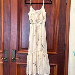 Lush mid length dress. Cream color with floral details. Size S